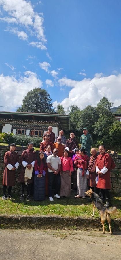 Partner meeting group photo at a Bhutanese dzong in the mountains
